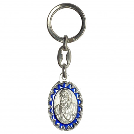 Face avant porte-clés ovale Mère Térésa métal argenté émaillé bleu H.3,8cm